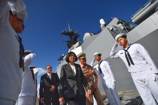  A handout picture made available by the Office of the President of Taiwan shows Taiwanese President Tsai Ing-wen (C) walking to board the Taiwanese Navy warship Kang Ding before it sets sail to Taiping Island in the South China Sea on July 13, 2016. Photo courtesy of the Office of the President of Taiwan