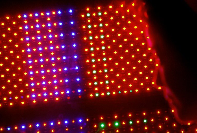 Photo taken on June 11, 2008 in Taipei shows a vistor walking past a Light Emitting Diode (LED) lights pannel displayed at the World Trade Center during the Photonics Festival. Sam Yeh/AFP