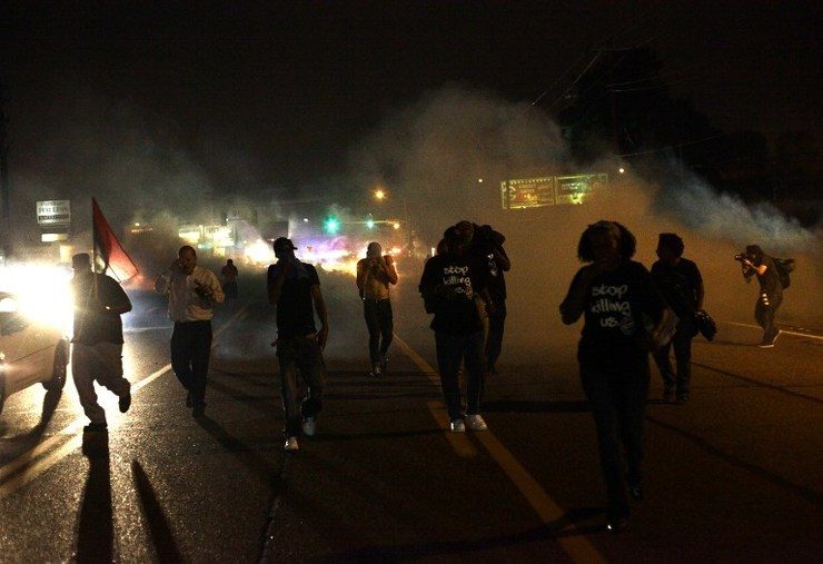 CHAOS IN FERGUSON. Tear gas and smoke wafts around the site of a protest of the death of Michael Brown August 17, 2014 in Ferguson, Missouri. Joshua Lott/Getty Images/AFP