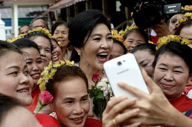Thai ex-PM Yingluck defies army with selfie and smiles tour