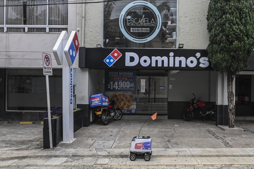 Colombian on-demand services start up Rappi is using wheeled robots designed by KiwiBot as a way of getting take out food to people who are forced stay home during lockdown as a preventive measure to slow the spread of COVID-19. Photo by Joaquin Sarmiento/AFP 