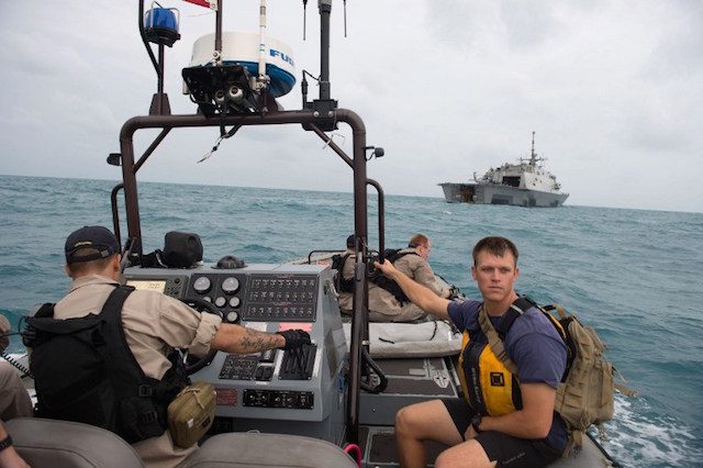 Sailors aboard the littoral combat ship USS Fort Worth (LCS 3) on January 4, 2015, making preparations to launch a tow fish side scan sonar system from the ship's 11-m rigid hull inflatable boat while conducting search and recovery operations in support of the Indonesian-led AirAsia flight QZ8501 search efforts in the Java Sea.  Photo from US Navy/AFP