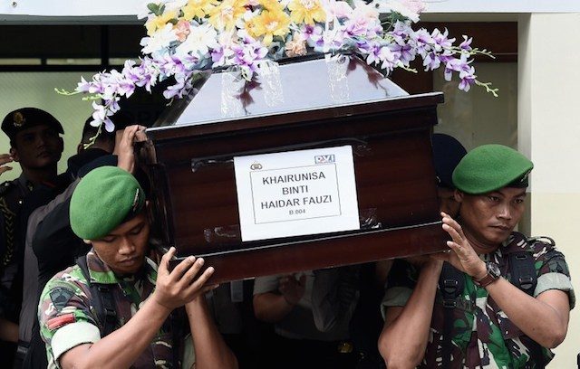 Indonesian military personnel carry the coffin containing the remains of Khairunisa Binti Haidar Fauzi, one of the flight attendants from AirAsia flight QZ8501, at the police hospital in Surabaya on January 2, 2015.  Photo by Manan Vatsyayana/AFP