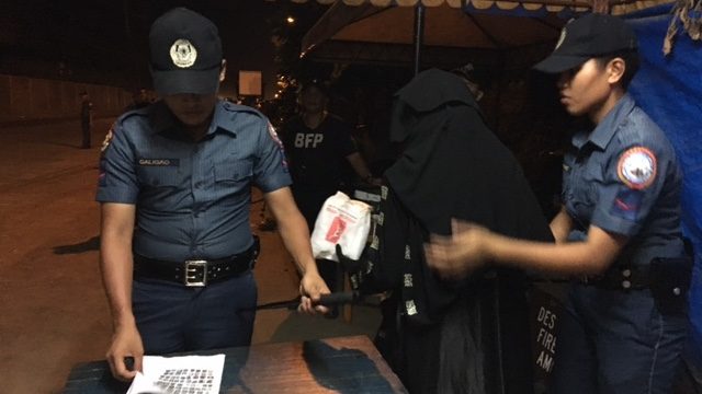 WANTED TERROR LIST. Security officers manning checkpoints are given photos of personalities in the military's 'Wanted Terror List.' Rappler photo 