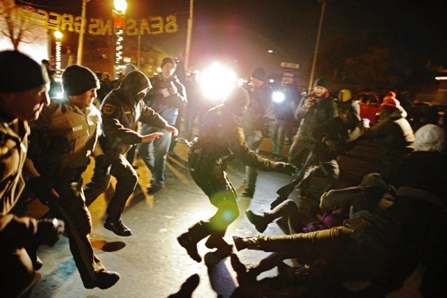 AWAITING VERDICT. Police rush in to break up protesters outside the Ferguson Police Station in Ferguson, Missouri, USA, November 20, 2014. File photo by Larry W. Smith/EPA