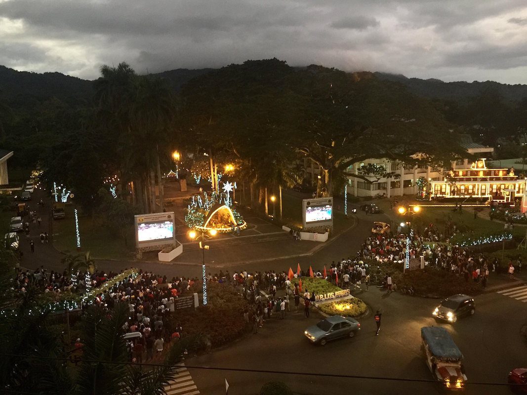 CAMP OUT. Students, employees, and alumni of UP Los Baños camp out at the UPLB gate to watch the winner-take-all duel. Photos by Stef Lacbayo/The Los Baños Times     