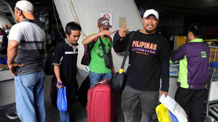 SAFELY HOME. Filipino workers arrive at Ninoy Aquino International Airport in Manila on August 2, 2014, after leaving strife-torn Libya. Photo by AFP/Jay Directo 