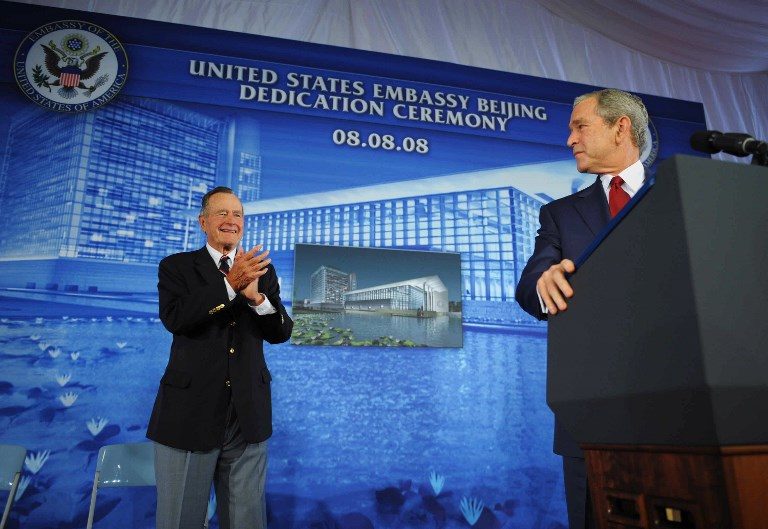 BUSH 41 and 43. In this file photo taken on August 7, 2008, former US president George H.W. Bush (L) applauds his son, US President George W. Bush, during the dedication ceremony of the new US embassy in Beijing. Photo by Mandel Ngan/AFP 