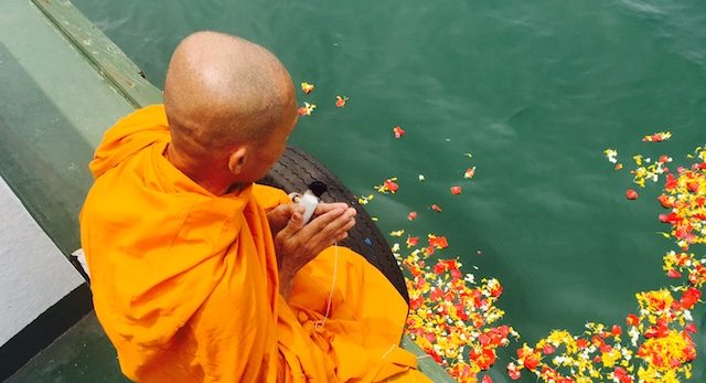 ONE WITH THE OCEAN. A Buddhist monk commits the ashes of Ko to the ocean. Photo from Walden Bello 