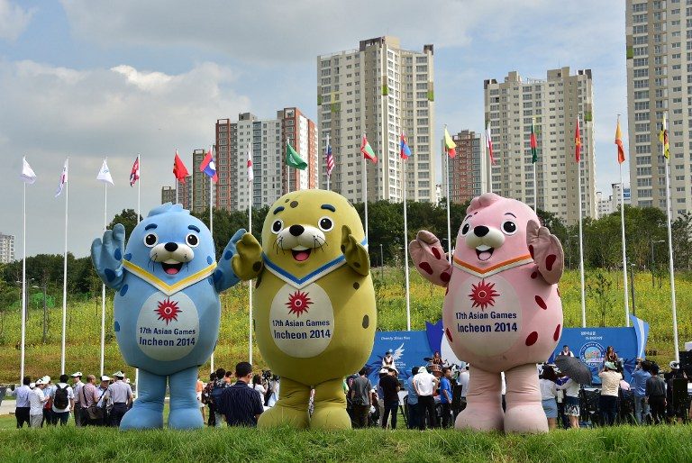 READY TO PLAY. Mascots named Barame (L), Vichuon (C) and Chumuro (R) pose on the flag plaza of the Athletes' Village for the 2014 Asian Games during a media tour in Incheon on August 26, 2014. Photo by Jung Yeon-Je/AFP