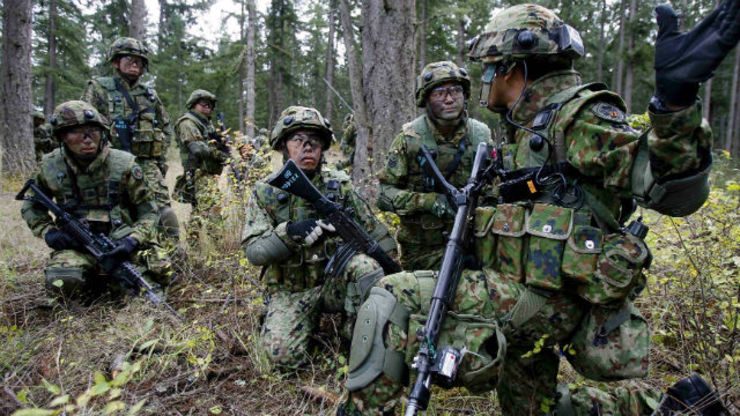 MILITARY POWER. Japanese soldiers from the 22nd Infantry Regiment of the Japan Ground Self-Defense Force train in urban assault with American soldiers from the 1st Battalion, 17th Infantry Regiment, 5th Brigade during an exercise at Fort Lewis’ Leschi Town. Photo courtesy of US Army