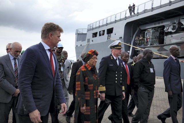 FIGHTING EBOLA. Liberian President Ellen Johnson Sirleaf (C) being escorted by Dutch Captain-Commander Peter van den Berg (C-R) and diplomat Hans Docter as the Netherlands’ Special Envoy for Ebola (2-L) towards the Dutch Navy's ship Karel Doorman shortly after it docked carrying humanitarian, relief and medical supplies at the Freeport of Monrovia, Liberia, 24 November 2014. Photo by Ahmed Jallanzo/EPA