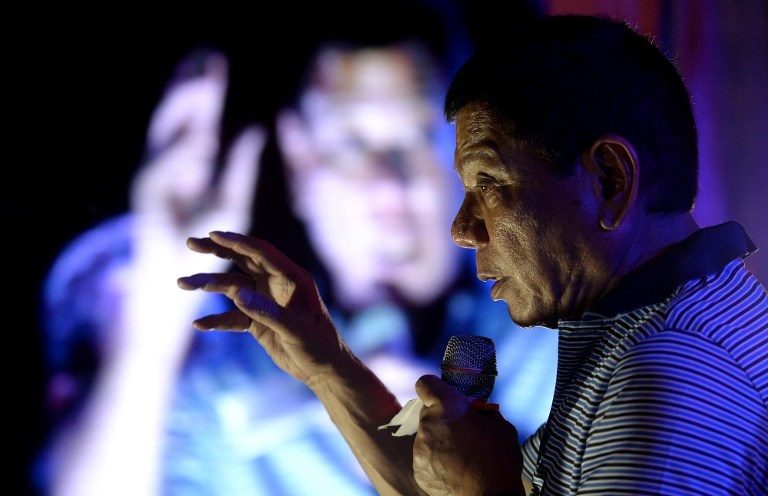 DIGONG. Philippine presidential front-runner candidate Rodrigo Duterte (C) states his political platform in front of his supporters during a campaign in Manila on April 23, 2016. Photo by Noel Celis / AFP   