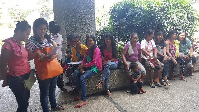 BREADWINNERS. The wives and children of the forest guards wait for them outside the MWSS building lobby. 