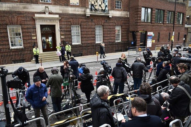 FRENZY. Members of the media take their positions outside the Lindo wing at St Mary's hospital in central London, on May 2, 2015 after the announcement was made by Kensington Palace that Catherine, Duchess of Cambridge, Prince William's wife, was admitted to hospital on May 2 in the early stages of labor with her second child. Leon Neal/AFP 