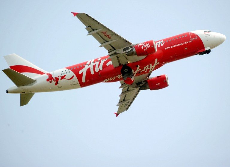 This picture taken on February 15, 2012 shows an AirAsia airplane is flying over the Sukarno-Hatta airport in Tangerang, near Jakarta, Indonesia. Photo by Adek Berry/AFP 
