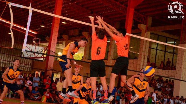An NCR secondary boys volleyball player spikes past Northern Mindanao defenders. Photo by Jerome Monta/Rappler