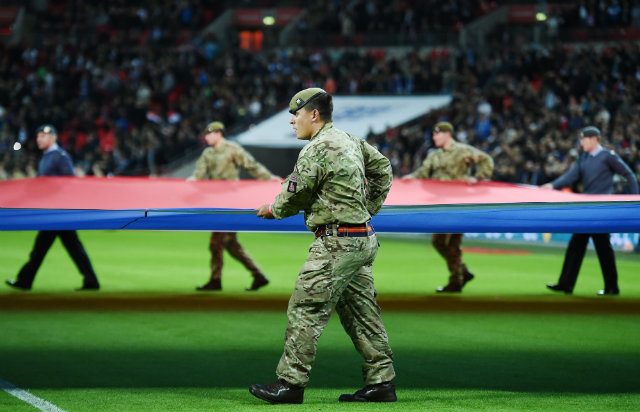 HONOR. British soldiers carry the French tricolor flag prior to the start of the friendly match between England and France at Wembley Stadium. Photo by ANDY RAIN/EPA 