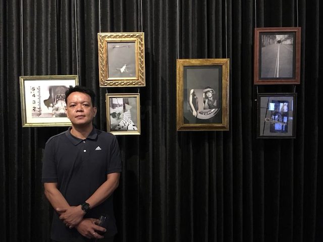 WIRE TUAZON. The visual artist with some of his works at the 'Neutral' exhibit. Photo courtesy of Sandra Aguinaldo 