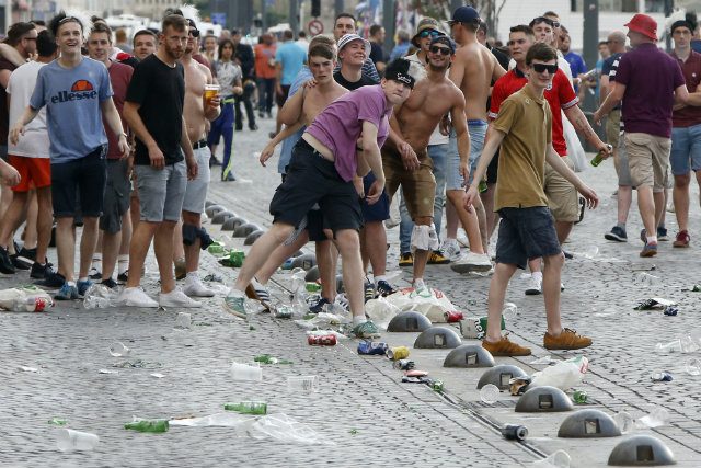Fans throw objects at riot police during clashes between English and Russian supporters at the Old Port of Marseille, France, 10 June 2016. Photo by GUILLAUME HORCAJUELO/EPA 