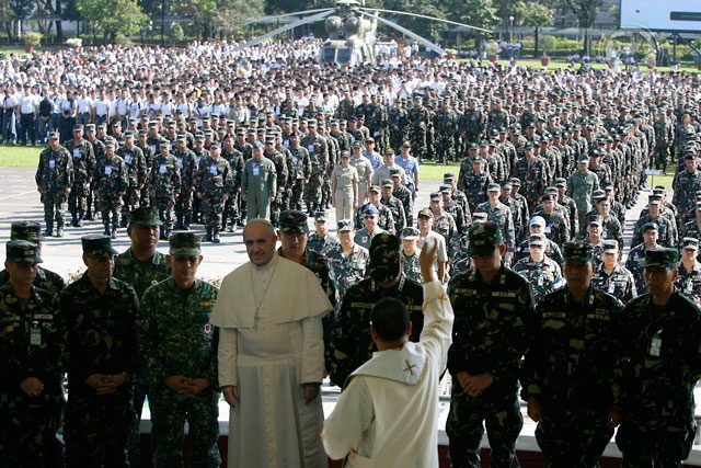 12,000 STRONG. A priest bless the members of the Armed Forces of the Philippines during the mustering of troops for the Joint Task Force Pope at Camp Aguinaldo, January 11 as part of the preparation for the papal visit on January 15 to 19. Photo by Ben Nabong/Rappler