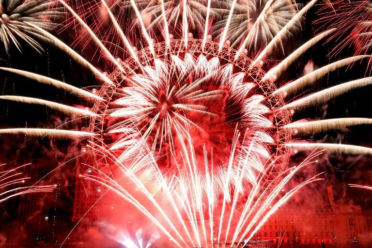 UNITED KINGDOM. Fireworks explode around the London Eye during New Year's celebrations in central London just after midnight. Photo by Adrian Dennis/AFP 
