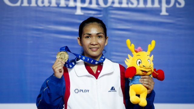 Josie Gabuco shows off her light flyweight gold  from the AIBA boxing championships in 2012. Photo by Diego Azubel/EPA
