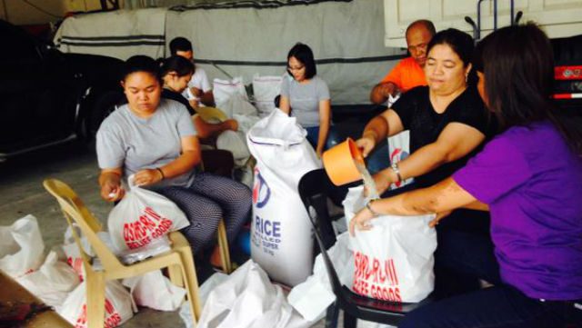 FOOD PACKS. Staff of DSWD Central Luzon distribute food packs for families affected by typhoons. Photo from DSWD Central Luzon   