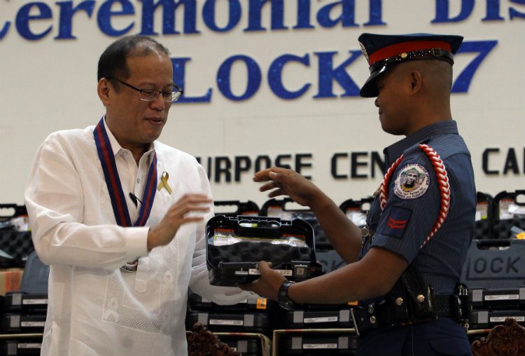NEW GUNS. President Benigno S. Aquino III distributes brand new Glock 17 pistols to PNP personnel in a ceremony at the PNP Multi-Purpose Center in Camp Crame, Quezon City on July 02, 2013. File photo by Benhur Arcayan/Malacañang Photo Bureau