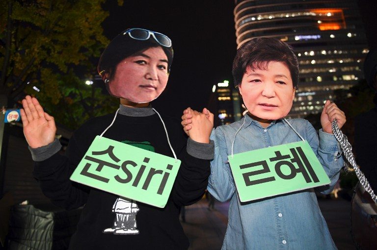 Raids, protests pressure S. Korea’s scandal-hit president