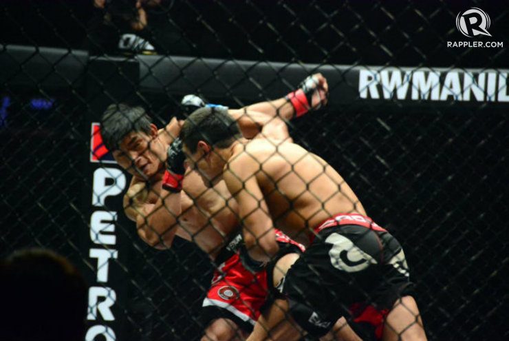 Eduard Folayang takes a right hand from Russian Timofey Nastyukhin. Photo by Jaelle Nevin Reyes