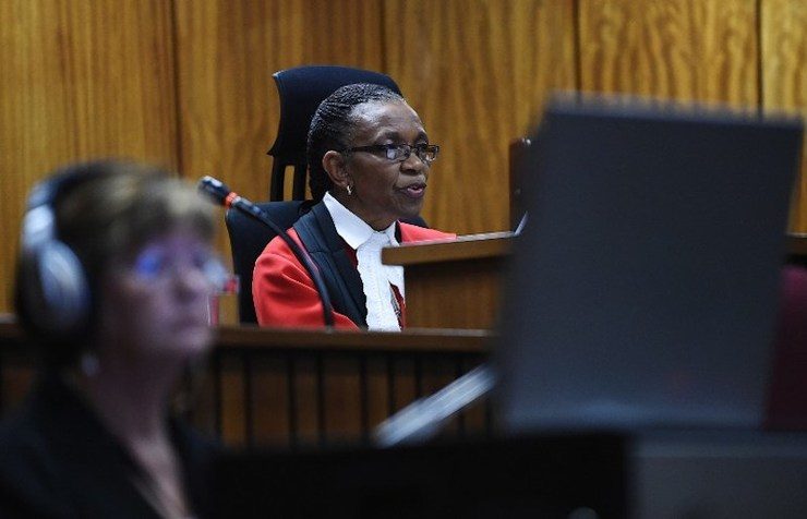 Judge Thokozile Masipa hands down her verdict on September 11, 2014 at the High Court in Pretoria on whether South African paralympian athlete Oscar Pistorius is guilty of the 2013 Valentine's Day murder of his model girlfriend. Phill Magakoe/Pool/AFP