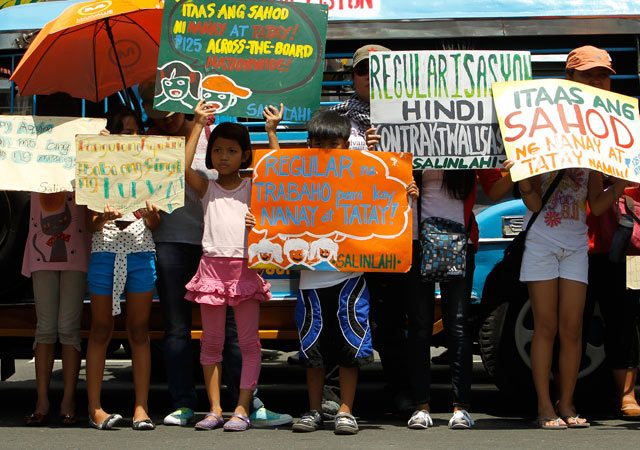 KIDS PROTEST. Filipino children hold placards during a protest to mark Labor day in Manila, Philippines, May 1, 2014. Photo by Ritchie B. Tongo/EPA