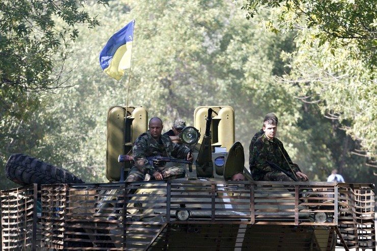 Ukrainian servicemen sit atop an armored personnel carrier (APC) as they ride near Donetsk, eastern Ukraine, on September 6, 2014. Anatolii Stepanov/AFP