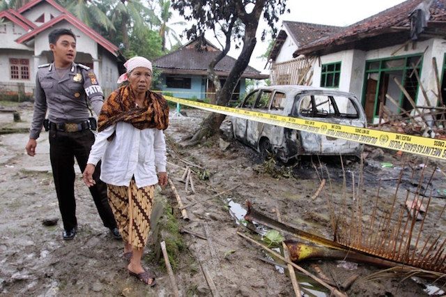 UNDER ATTACK. Aminah, a member of the minority Ahmadiyah Islamic sect, inspects her damaged house where her son was killed together with two others after a mob attacked their village on February 6, 2011 in Pandeglang, Banten province.  Photo by Nurani Nuutong/AFP 