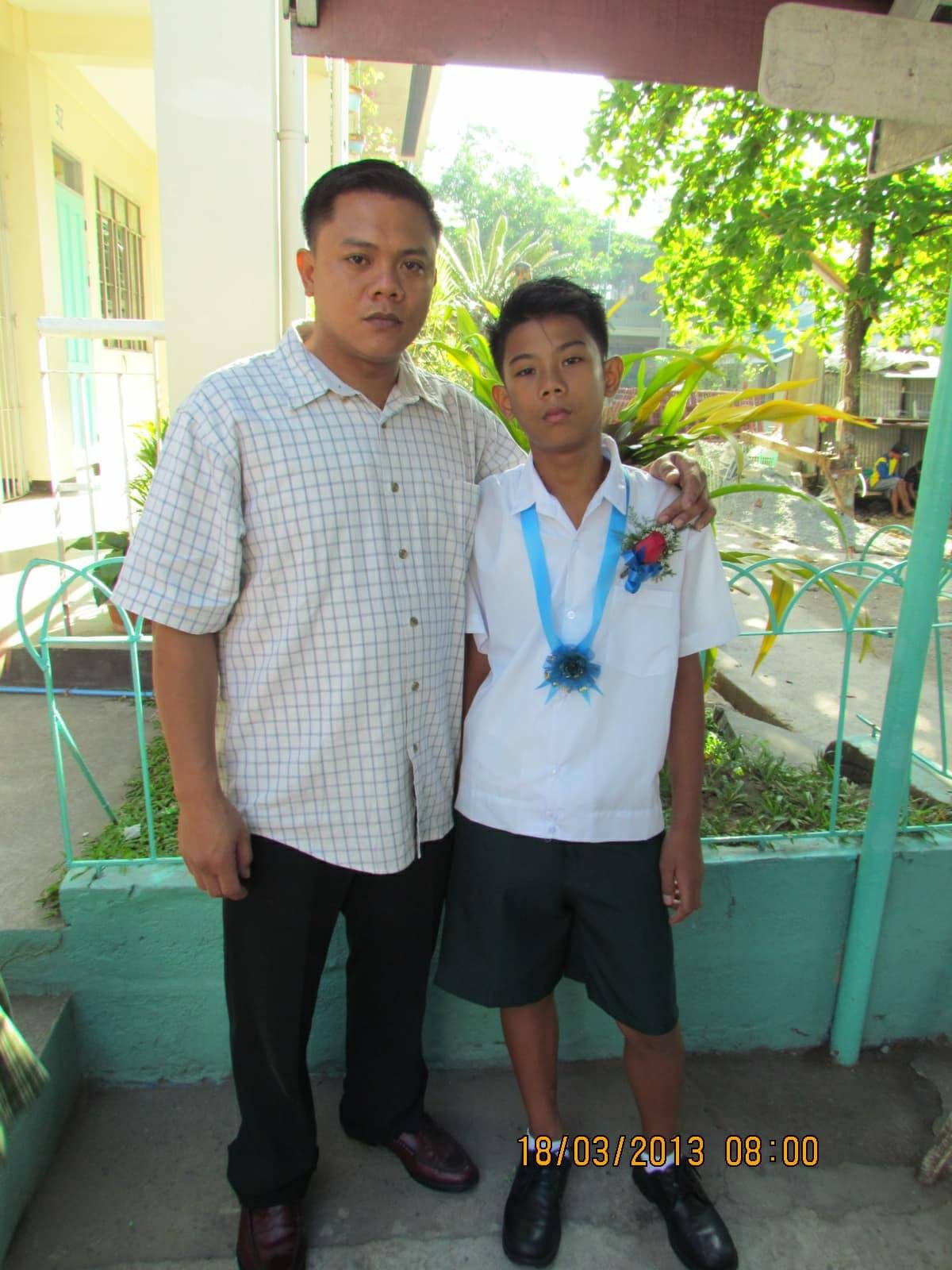 PROUD. Joaquin poses with his son Kiesten during his elementary graduation. Photo from Joaquin Nonan  