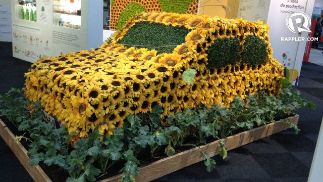 FLOWER POWER. A car is covered with sunflowers to represent how innovators are now finding ways to create more environmentally-friendly vehicles. 