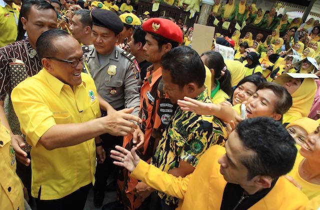 WHO'S THE REAL CHAIRMAN? Aburizal Bakrie (L) is greeted by his supporters during an election campaign rally in Medan, North Sumatra, in March 2014. A Golkar Party congress re-elected him chairman, but a rival camp has elected his former deputy Agung Laksono. File photo by EPA