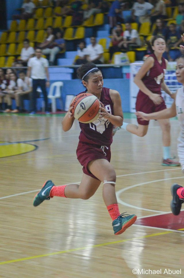 UP’s Jeanine Bautista (#9) drives to the hoop. Photo by Michael Abuel 