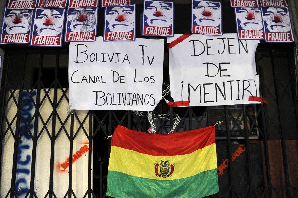 Protesters seize state-run media in Bolivia as tensions soar