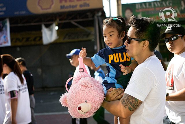 Camille Pabalinas, the 2-year-old daughter of the late SInsp Ryan Pabalinas during the March 8 'Sympathy Walk' for the SAF 44. Photo by Franz Lopez/Rappler 