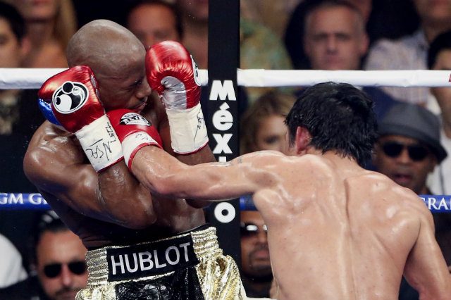 Pacquiao had success in the first half of the fight with straight left crosses between Mayweather's gloves. Photo by EPA 