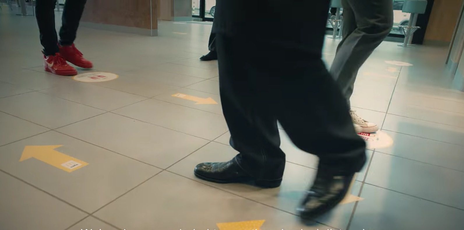 GUIDE. McDonald's stores have stickers on the floors for queuing and walking. Screenshot from McDonald's video 