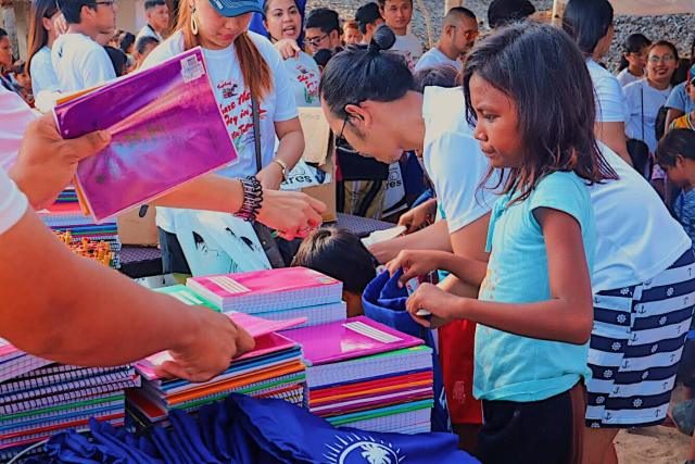SHARING THE BLESSINGS. Trapkada had 80 volunteers in their event in Jomalig to help distribute school supplies to 300 children. 