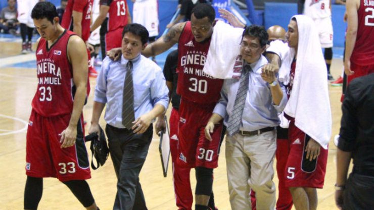 Ginebra import Zaccheus Mason is helped off the court after injuring his knee. Photo by Nuki Sabio/PBA Images