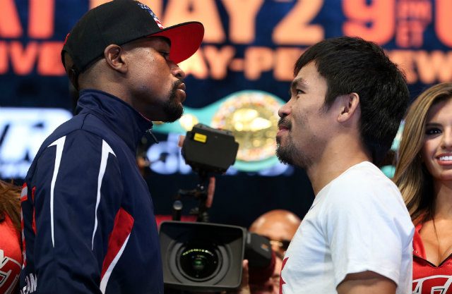 Floyd Mayweather and Manny Pacquiao stare off a night before they meet in the ring. Photo by Chris Farina - Top Rank  