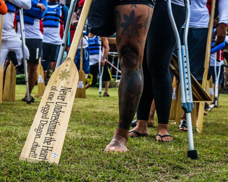 ONE-LEGGED DRAGON. Amputee and team captain Arnold Balais added his personal touch of motivational messages onto his paddle and calls himself a one-legged dragon. Photo by: Richale Cabauatan 