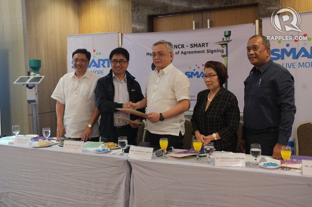PARTNERING UP. DOST and Smart Communications officials formalize an agreement for the co-location of cell sites and automated rain gauges. Photo by Pia Ranada/Rappler 