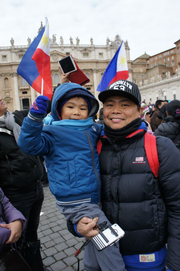 PHILIPPINE PRIDE. A father and son await the appearance of the Pope at his weekly Angelus in St Peter's Square  
