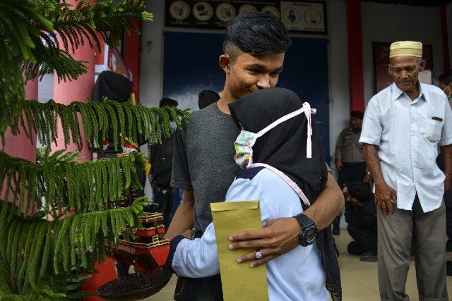 REUNION. A man hugs a family member after he was released from prison in Lhoknga near Banda Aceh in Indonesia. Photo by Chaideer Mahyuddin/AFP 